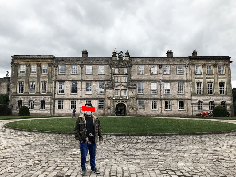 Arka Plan Değiştirme Hizmeti 8 Oxford Üniversitesi binasının önüne eklendikten sonra görüntüde yer alan adam